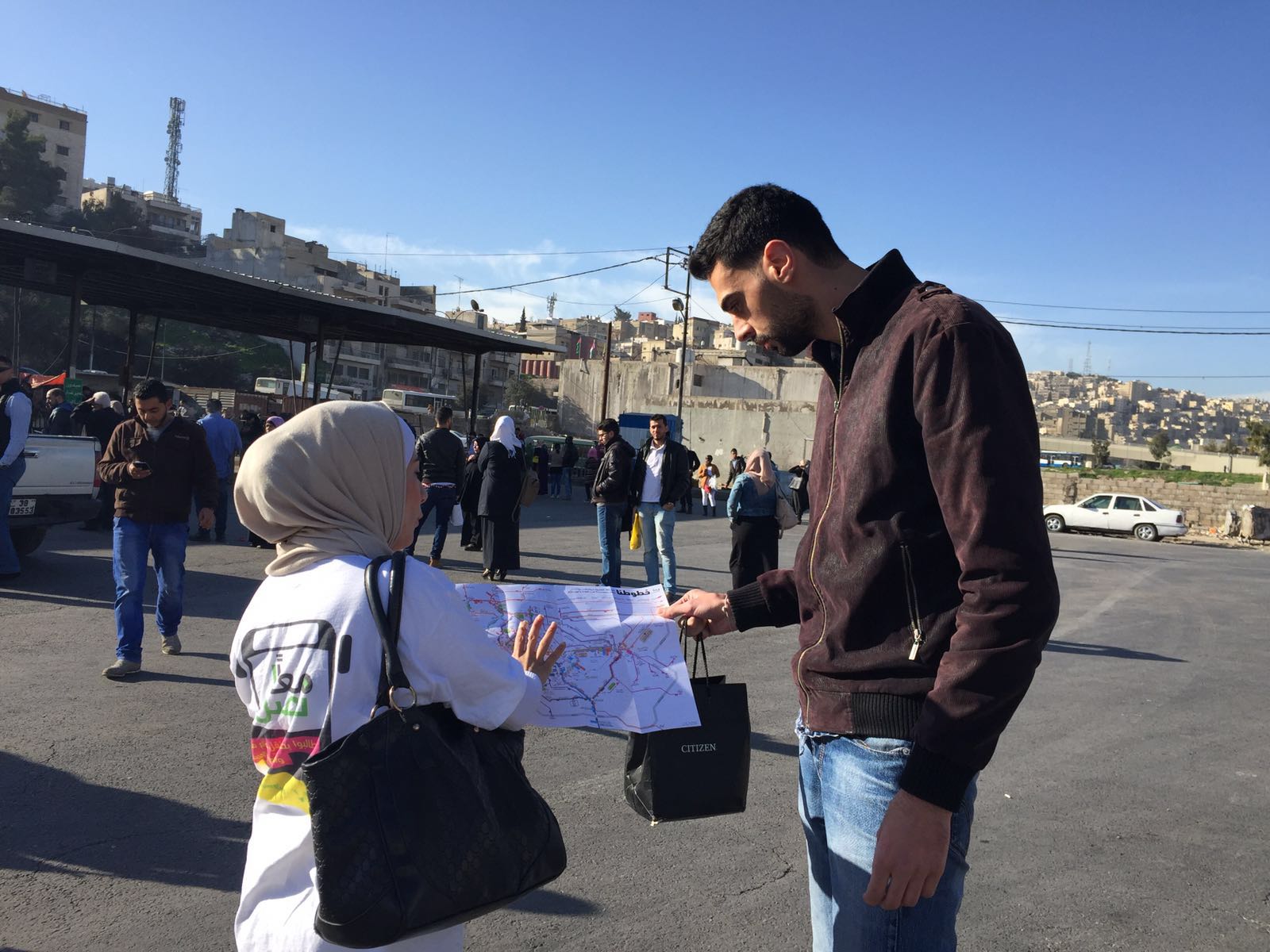 Maan Nasel volunteer distributing crowd-sourced public transport map 