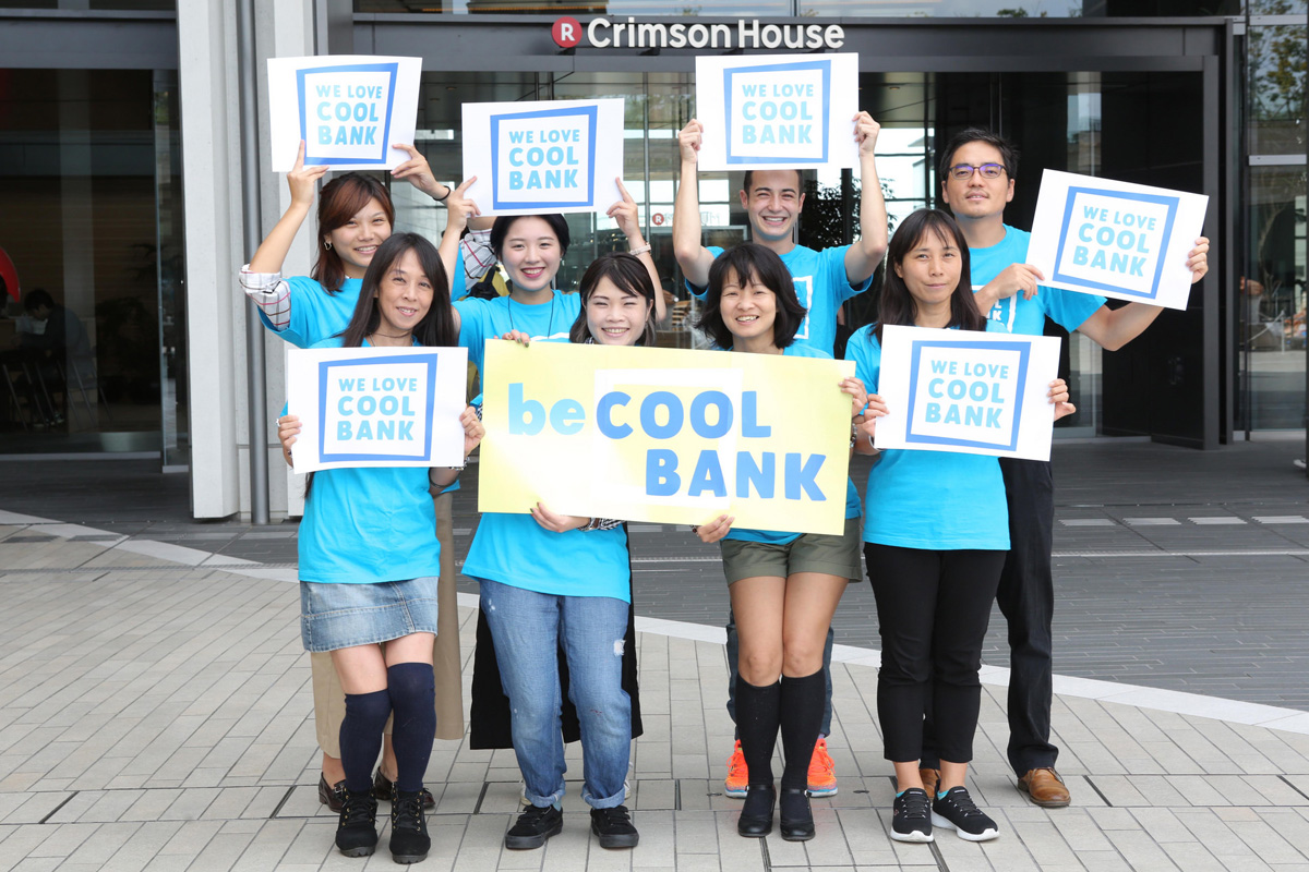 group of people holding signs that say we love cool bank