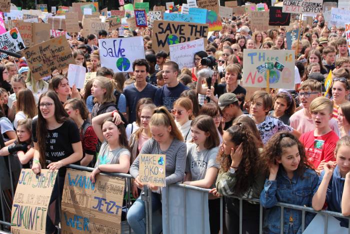 Youth school strikers in Berlin, Germany carrying placards with climate slogans