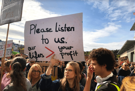 Young people at the Climate Strike in Berlin in September 2019 hold up a banner: "Please listen to us. Our lives > your profit.