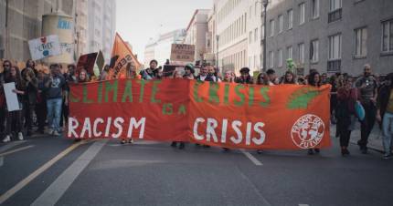 March for climate strikes with a banner that reads Climate Crisis is a Racism Crisis