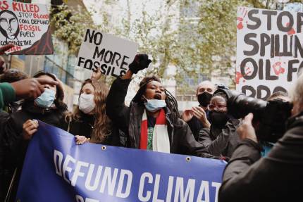 Young people protesting against fossil finance outside Standard Chartered Bank.