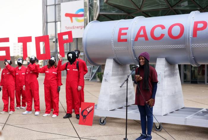 Climate activists organise an art performance in front of Total Energies headquarters in La Defense, France to denounce Total's climate wrecking pipeline project, the East Africa Crude Oil Pipeline.