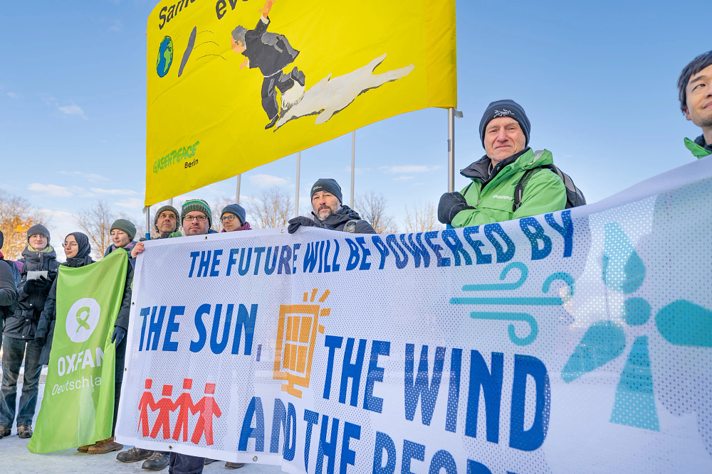 Climate activists hold a protest in Berlin to demand for corporations and the rich to pay for climate protection. Photo: Sabrina Gröschke