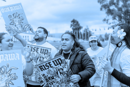 Five Pacific Climate Warriors stand with 'Rise Up' and 'Our Pawa' placards on the lawns of Parliament House, Canberra, Australia , May 2024.